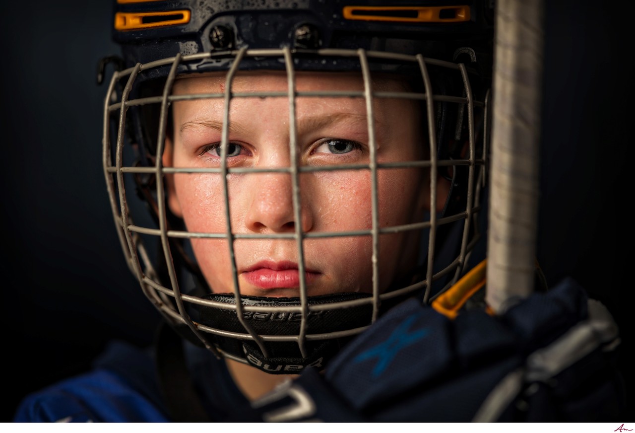Close-up of a Bedford Blues hockey player in his cage helmet, studio sports portrait, Halifax