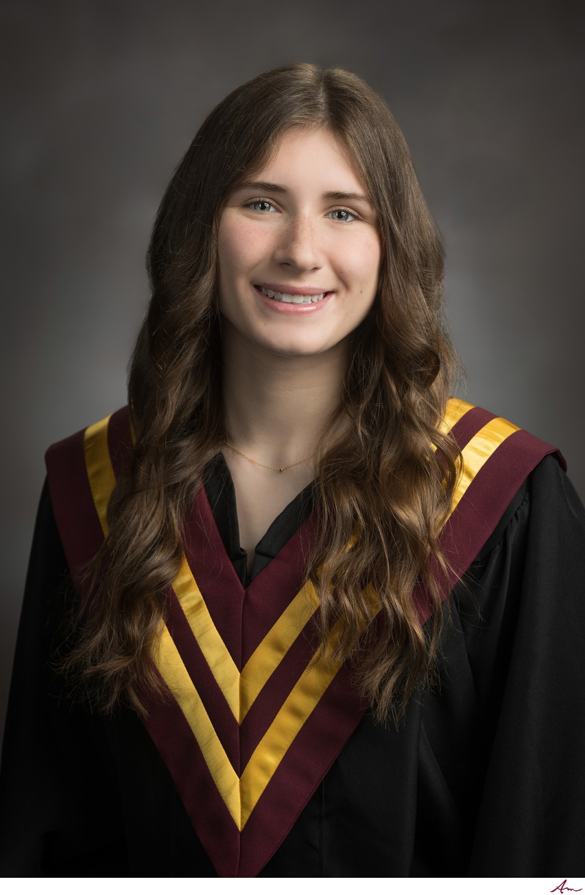 Citadel High senior in black gown with maroon sash and gold chevrons, studio portrait, Halifax