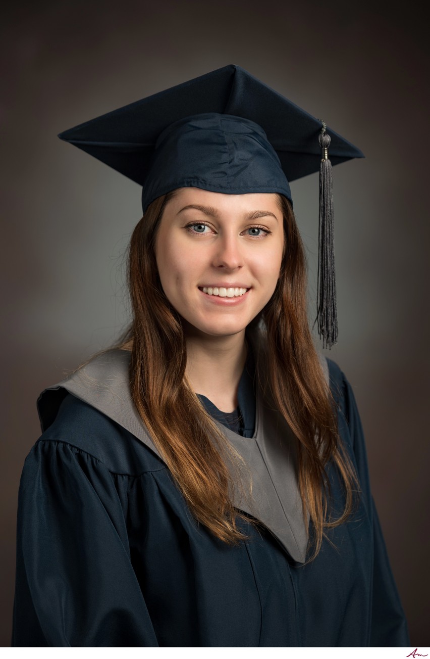Island View High graduate from Eastern Passage in navy cap and gown with grey stole, studio