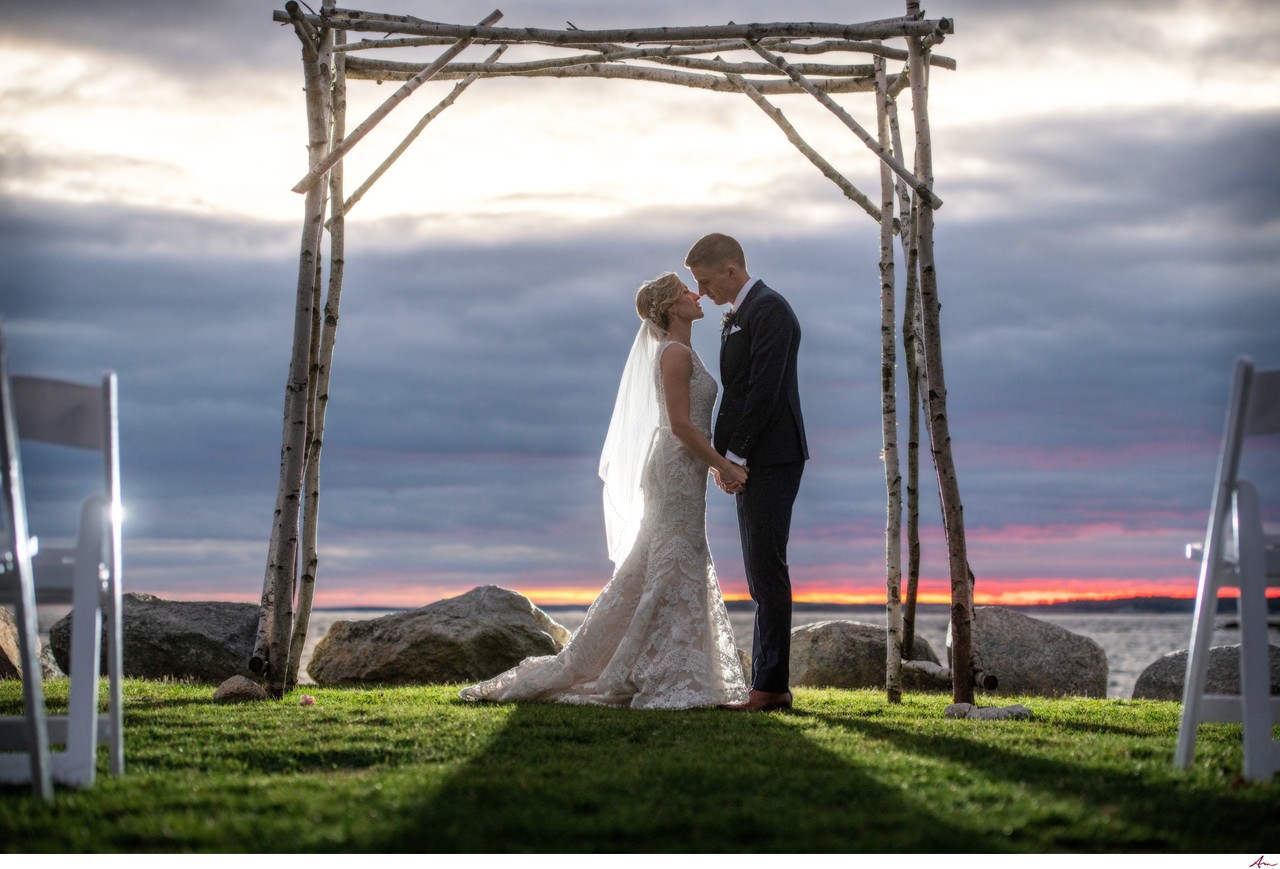 Wedding couple embracing at the water's edge at Oceanstone, Nova Scotia
