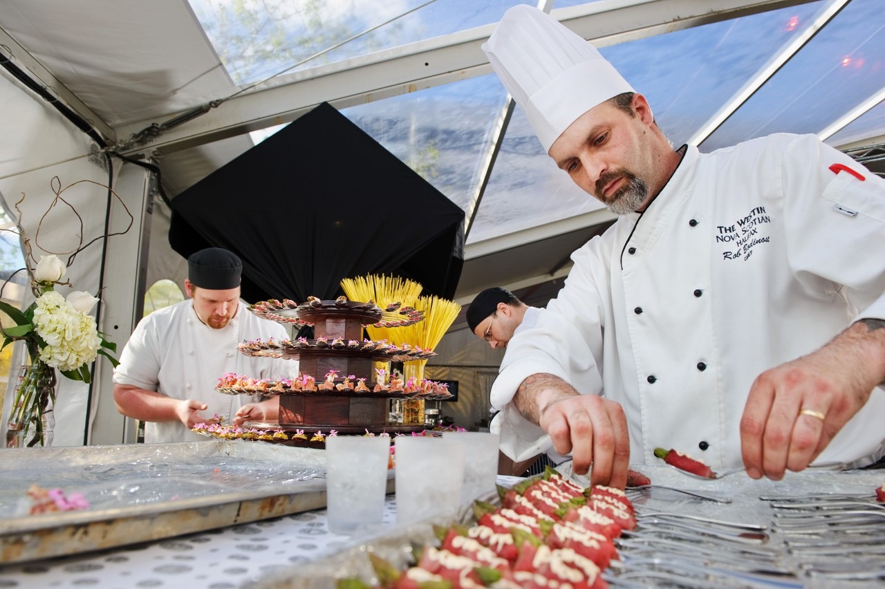 Westin Nova Scotian chefs plating appetizers on ice under a tent at an outdoor Halifax event