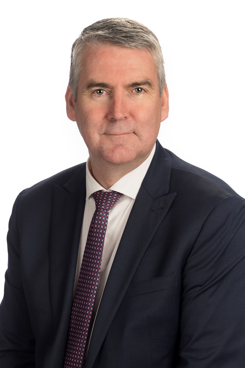Stephen McNeil, 28th Premier of Nova Scotia, in navy suit and patterned tie, headshot on white
