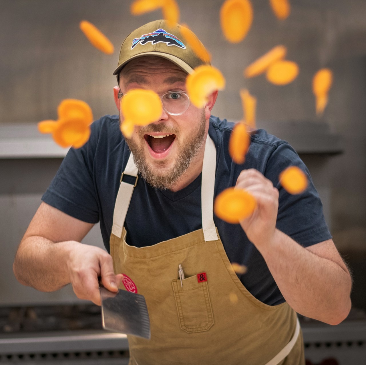 Chef Andrew Farrell tossing sliced carrots in the Kitchen Door kitchen, Dartmouth Nova Scotia