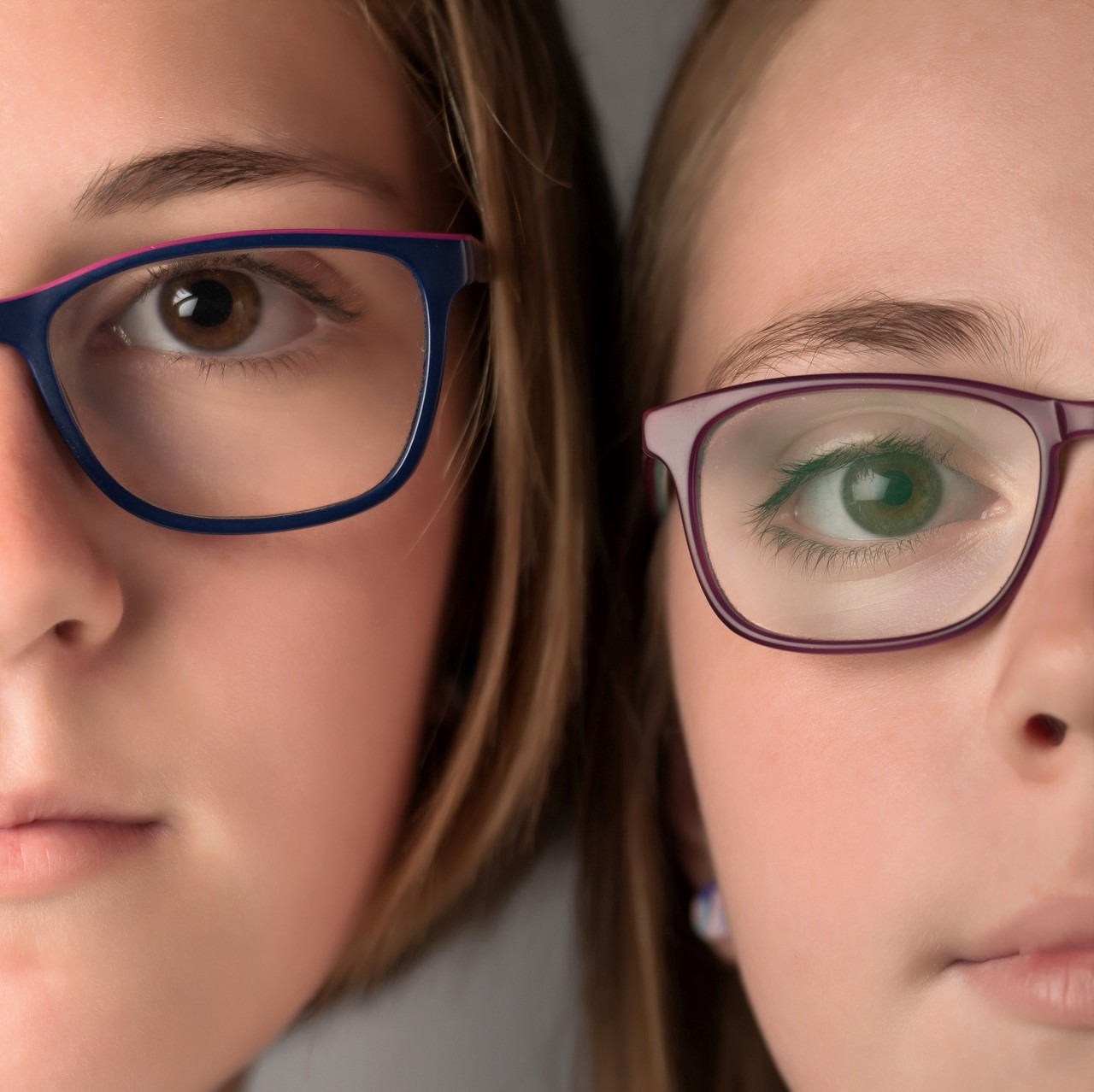Two Bedford sisters in glasses cheek to cheek, tight studio close-up, Halifax family portrait