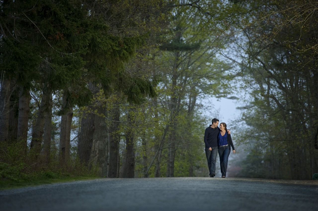 Engaged couple walking hand in hand in Point Pleasant Park, Halifax