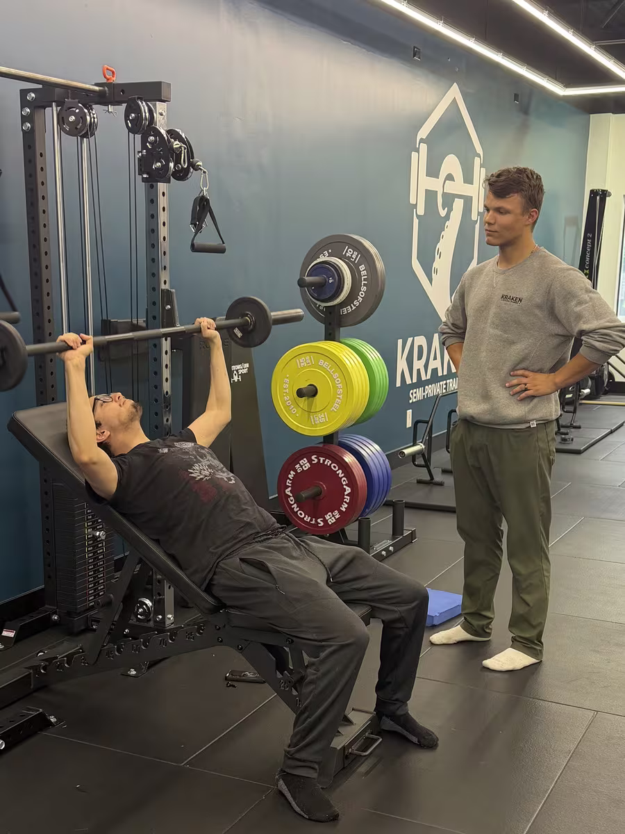 Julian coaching a client at the cable machine at Kraken Fitness in Burnaby