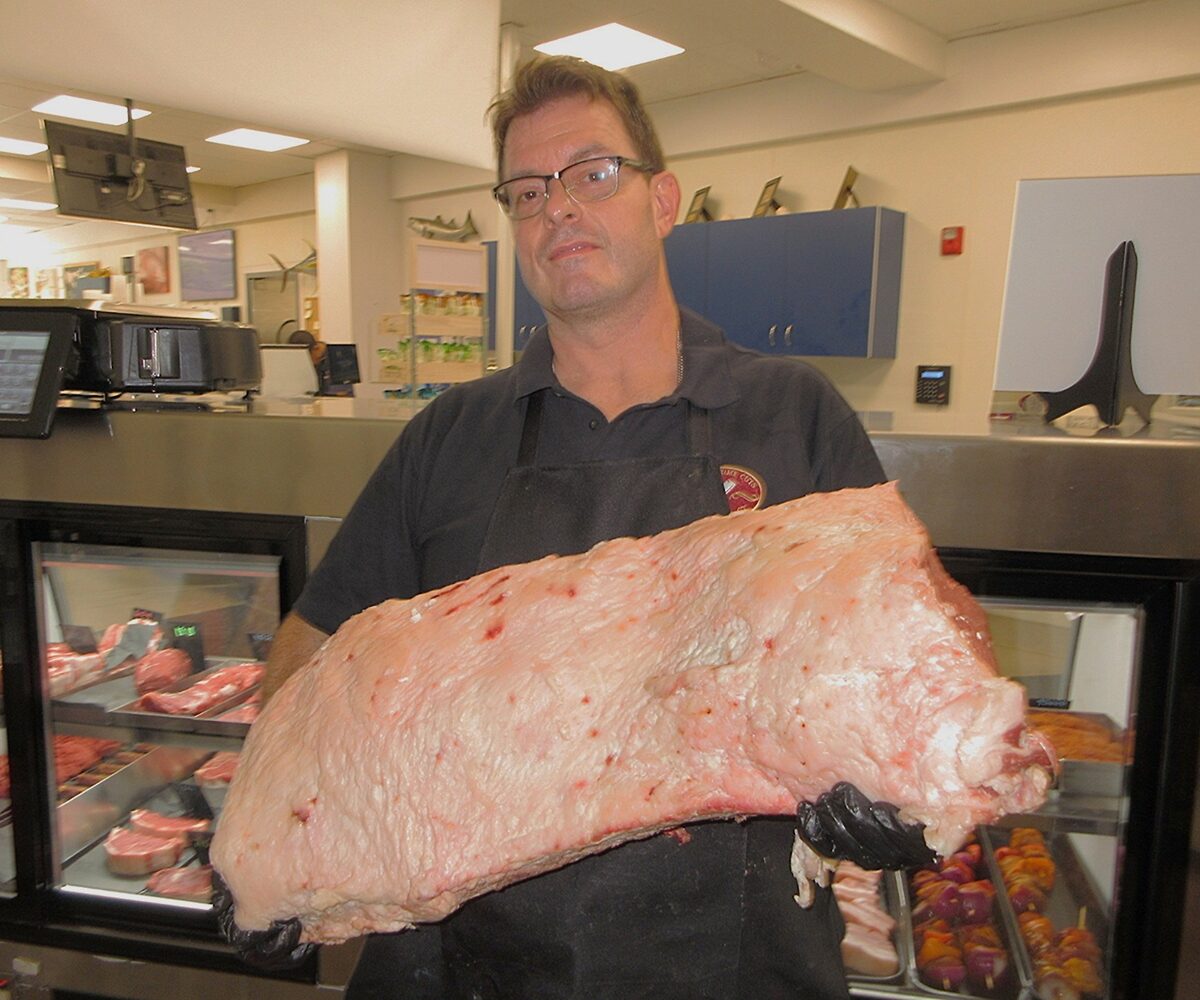Owner Chris Deenihan at the counter of Deenihan's Prime Cuts, your local butcher shop for grass-fed, antibiotic- and hormone-free meat.