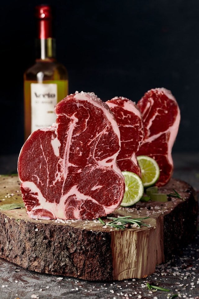 Marbled ribeye cuts on dark slate at Deenihan's Prime Cuts.