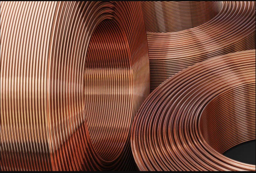 Coils of bright drawn copper rod, the raw material that begins every PTI cable run.