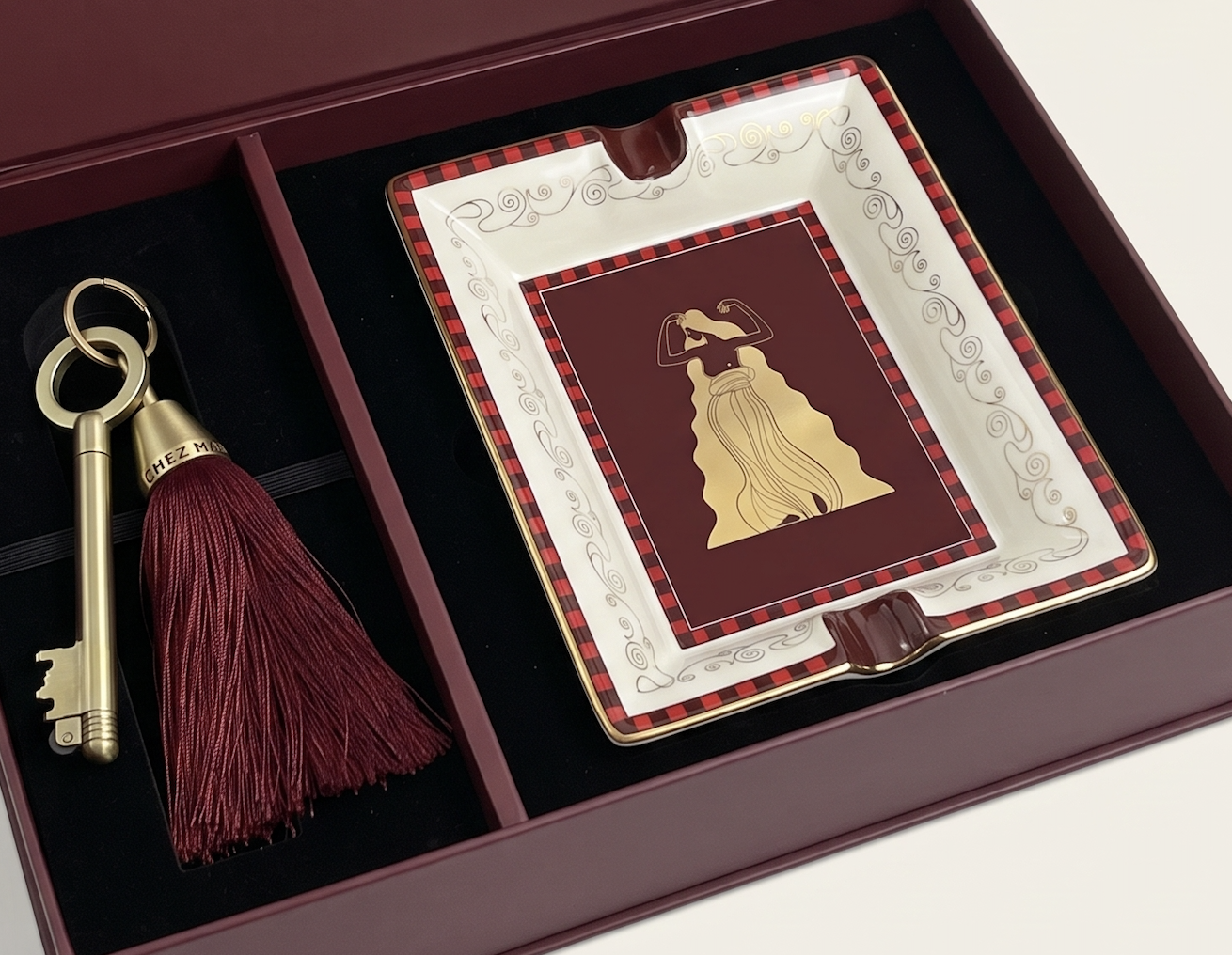 Photo of box with porcelain ashtray and key with tassel