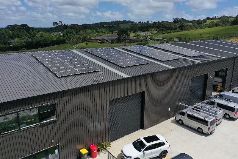 Aerial view of a commercial building with solar panels installed on the roof