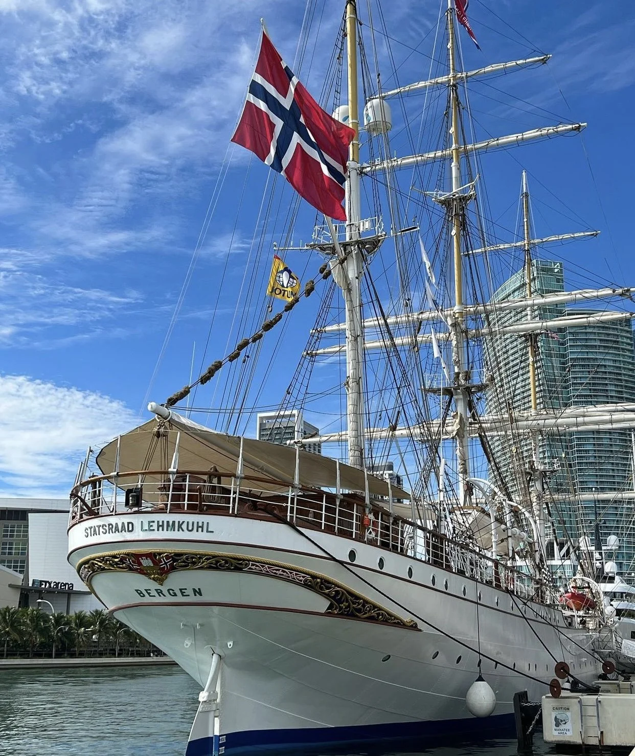 Norway’s oldest tall ship docked in harbour on a sunny day.