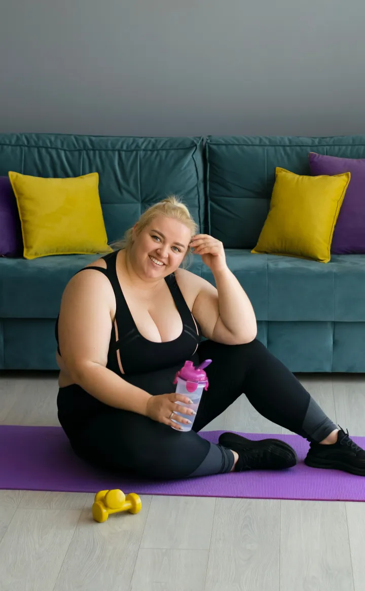 an obese lady relaxing in the middle of exercise