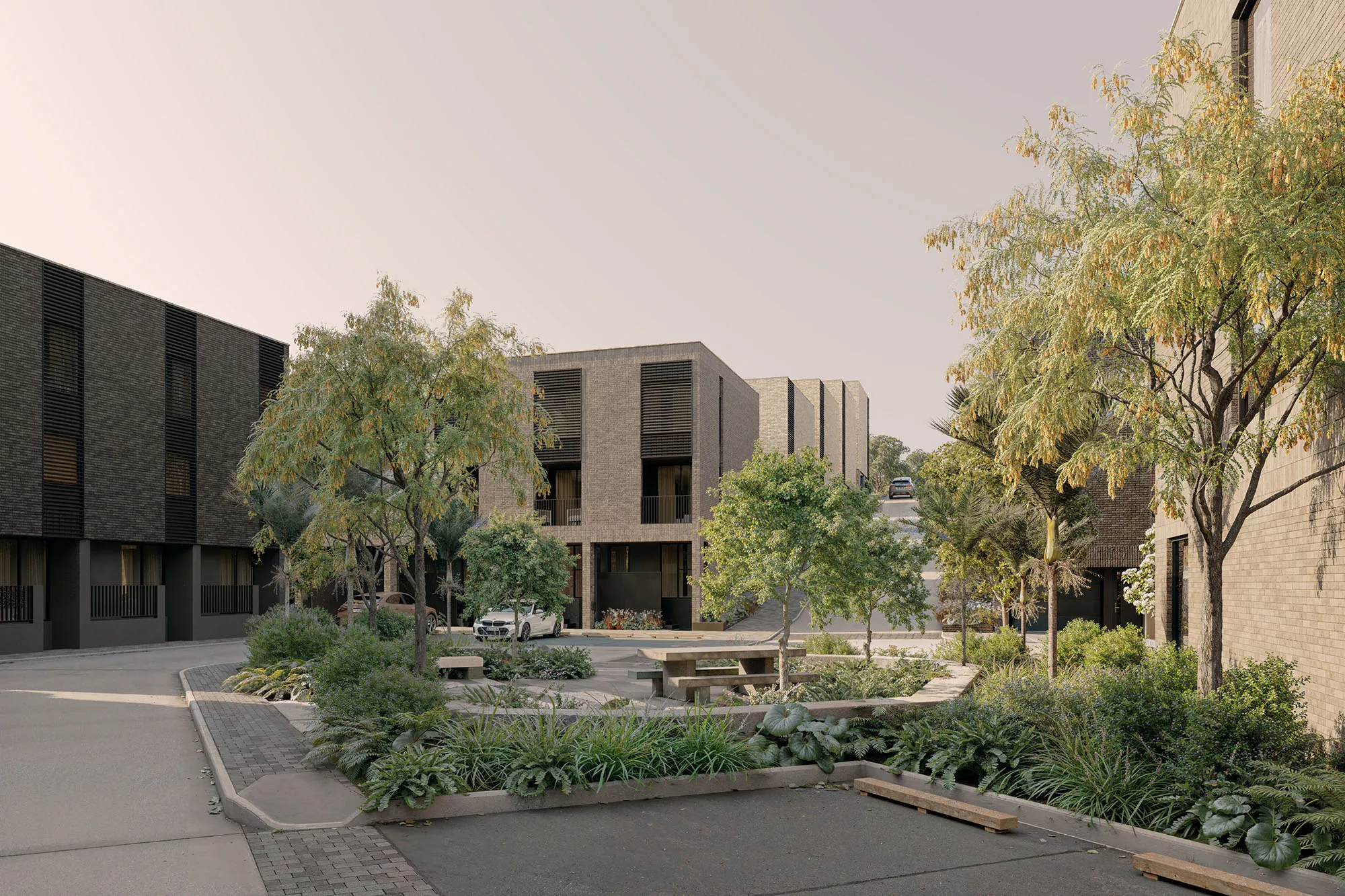Landscaped pocket park at the heart of Enclave, framed by brick townhouses and mature trees