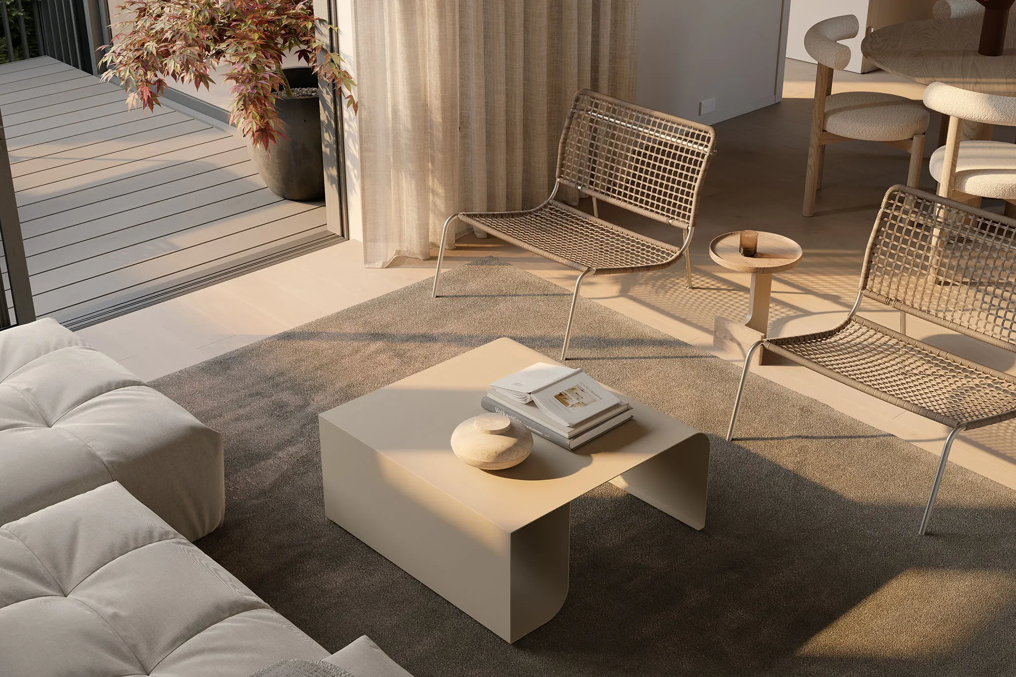 Living area detail at Enclave with woven lounge chairs beside an open deck