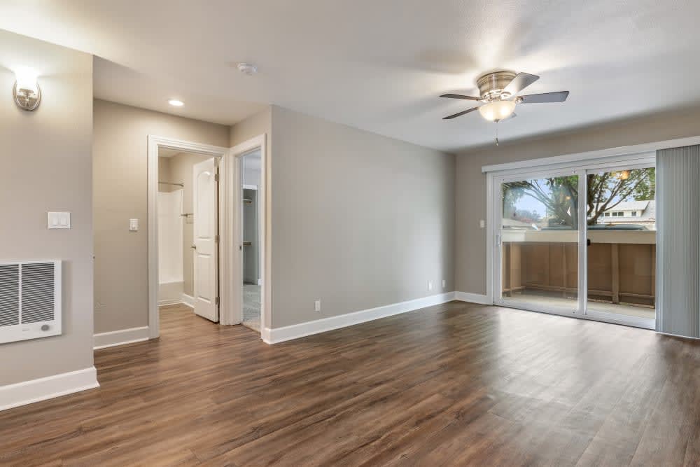 Unfurnished living area with view of balcony sliding doors and hallway
