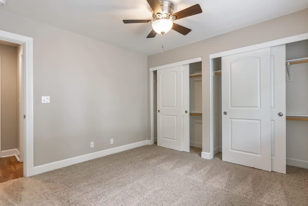 Unfurnished bedroom with carpet, closet and ceiling fan
