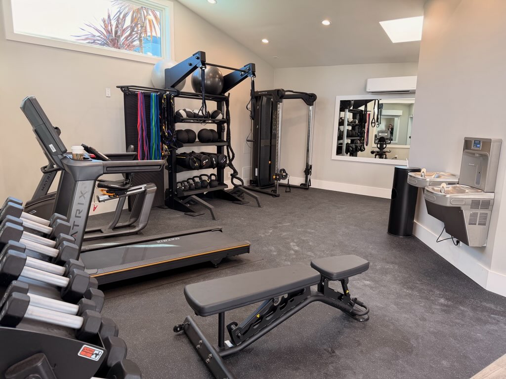 Fitness center with cardio and weight lifting equipment and 2 drinking fountains