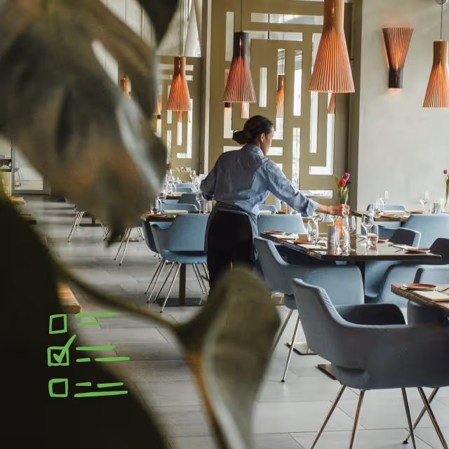 Server setting tables at restaurant