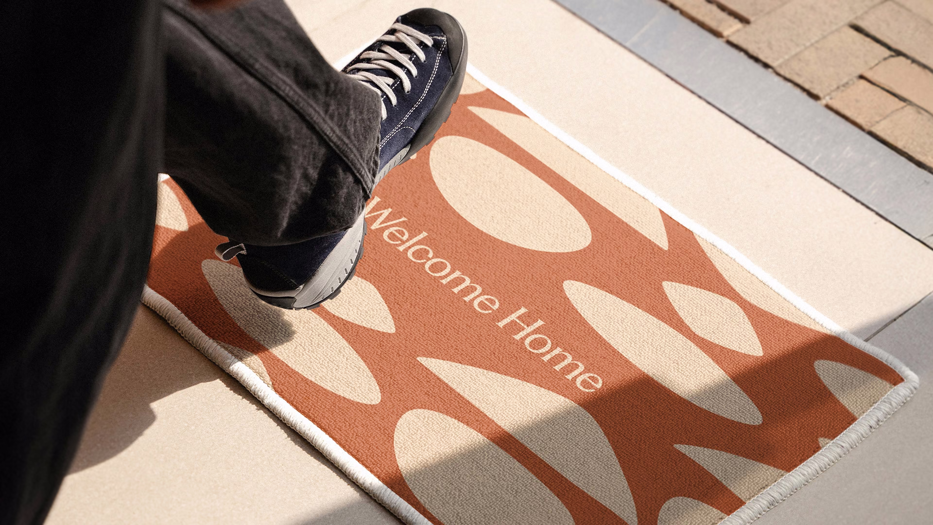 Cosa Mirai Welcome Home doormat with an abstract pebble stone pattern.