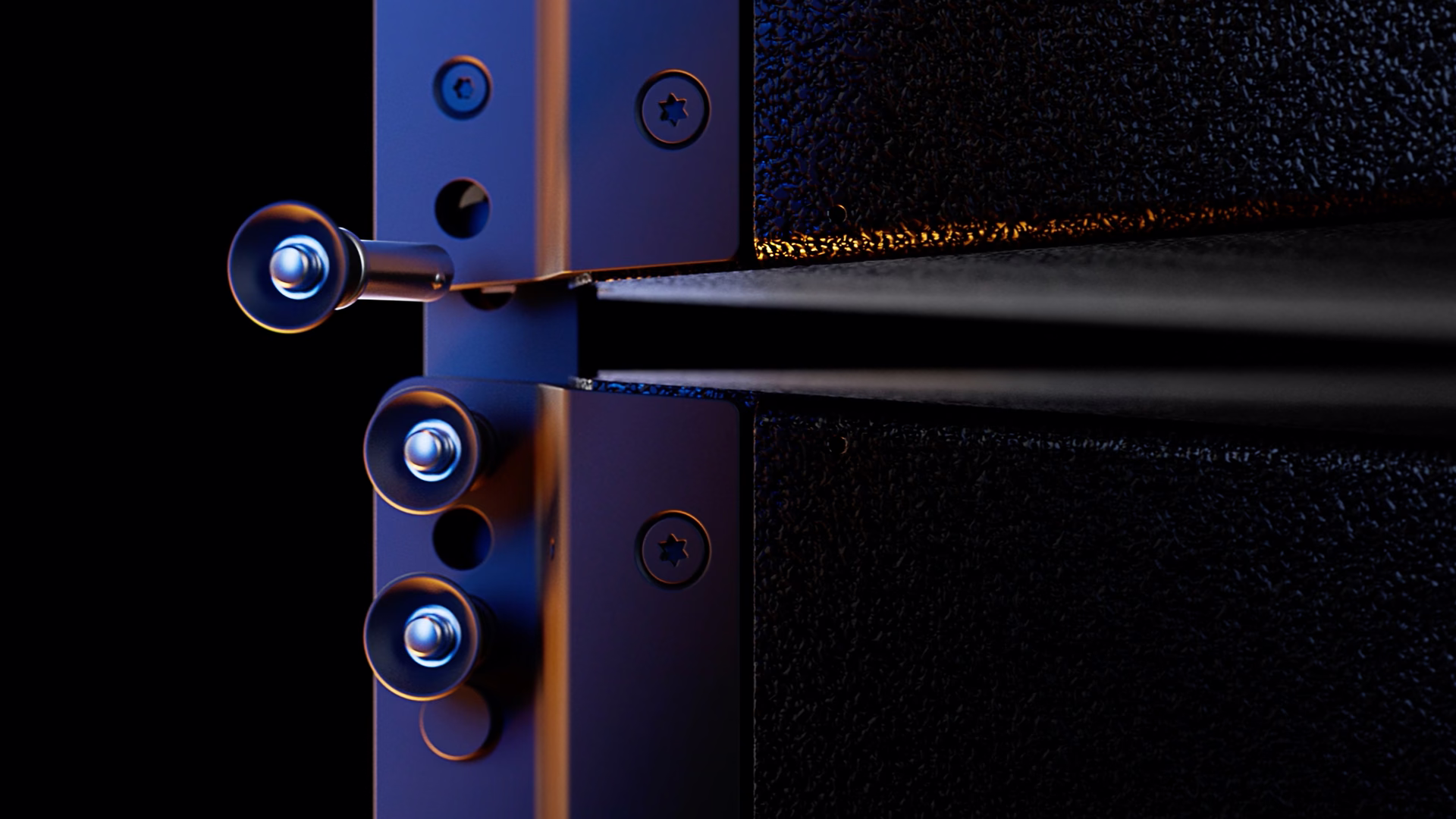 Close-up of d&b loudspeakers connecting with subtle orange lighting details.