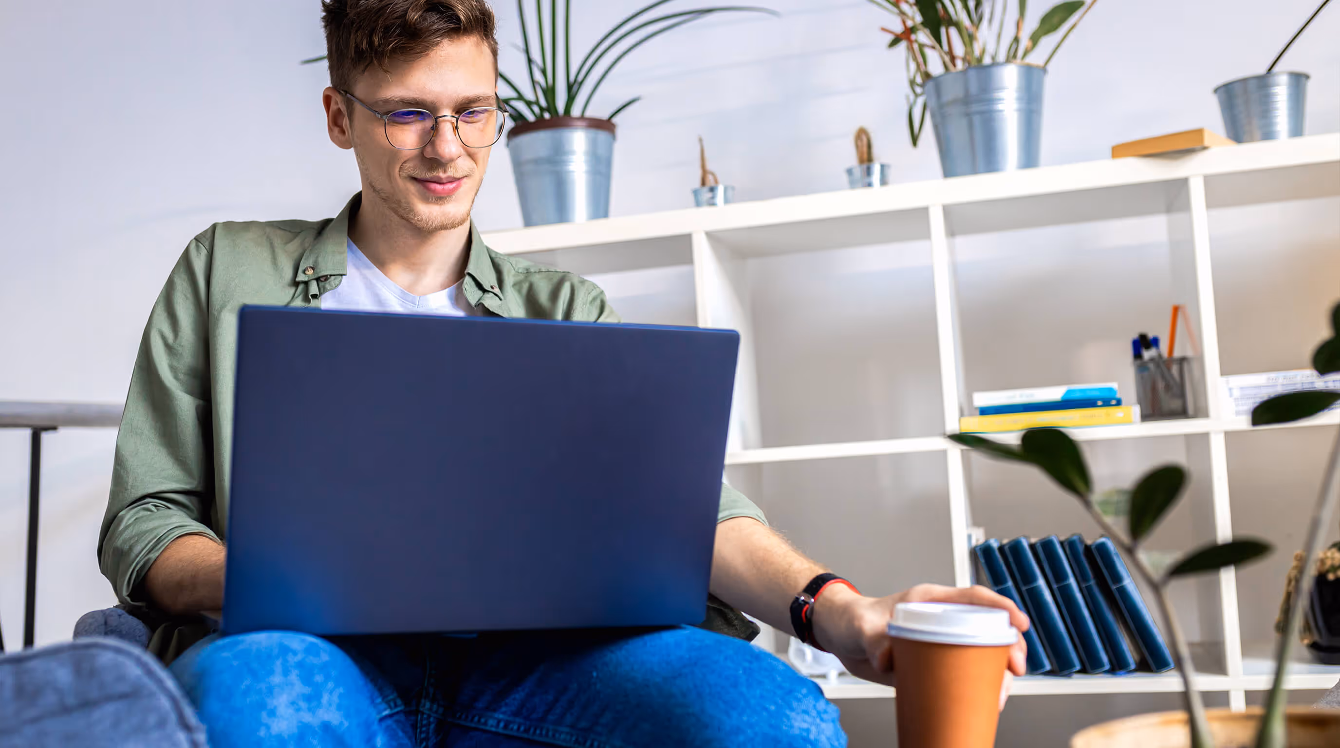 Man attending an online therapy session on a laptop from home