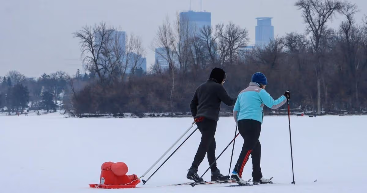 Sunset over Cedar Lake with the downtown Minneapolis skyline beyond the shoreline