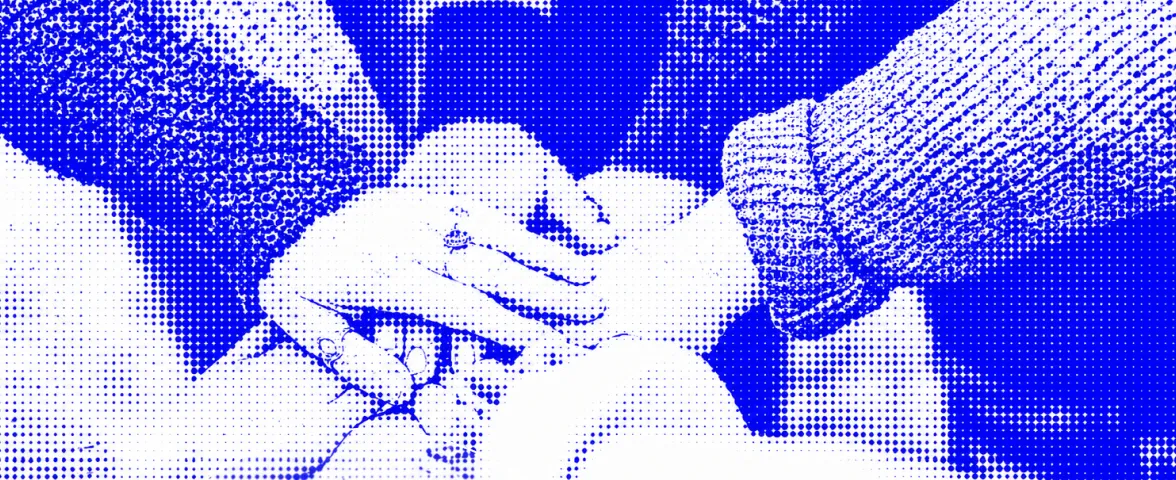 Multiple hands stacked together symbolizing unity and teamwork.