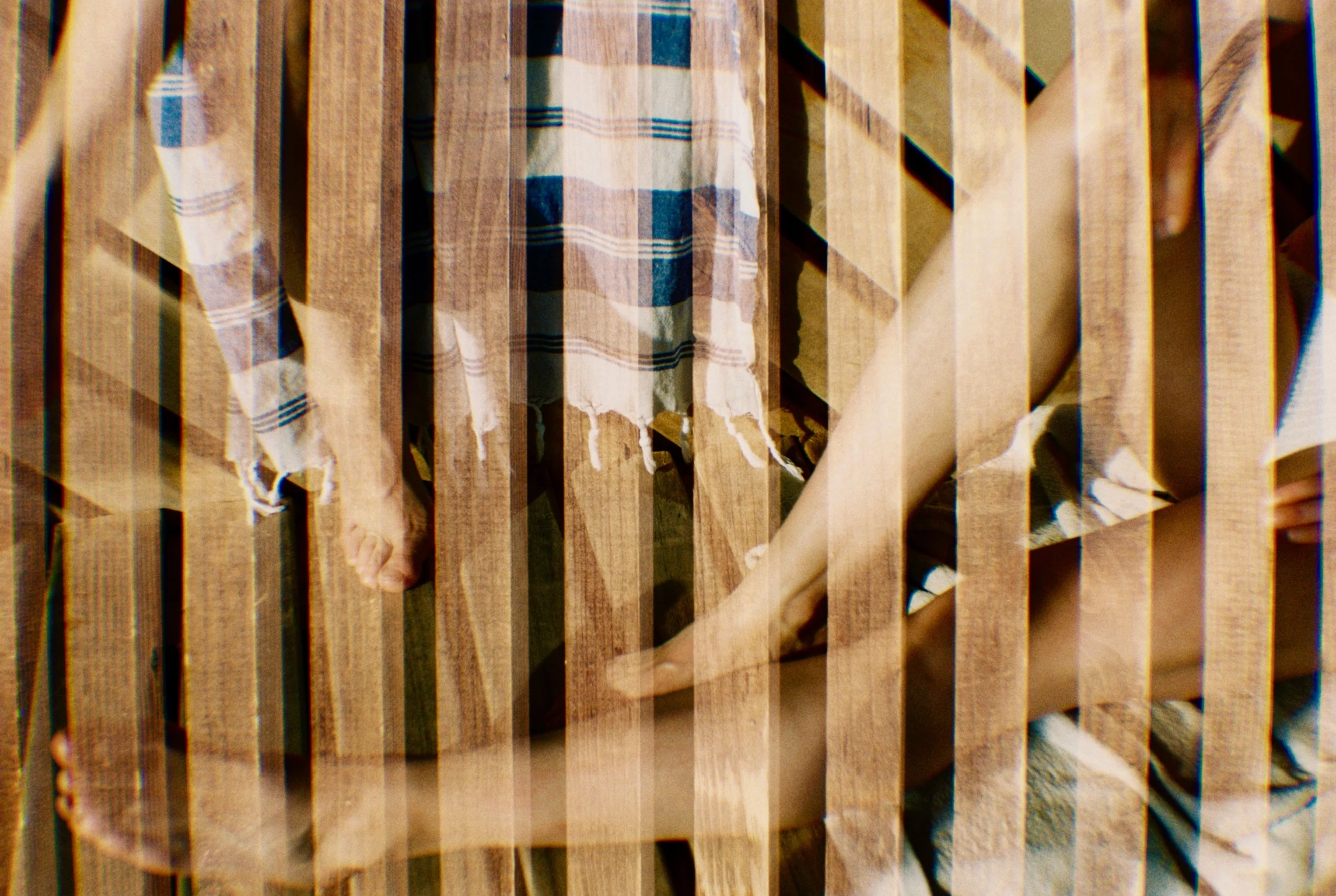 Woman in black swimsuit with eyes closed submerged in water with text 'DROPP SOCIAL SAUNA' overlay.