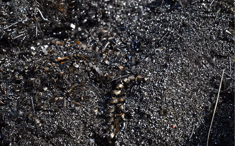 Close-up view of metallic metal shavings and spirals from machining or metalworking.