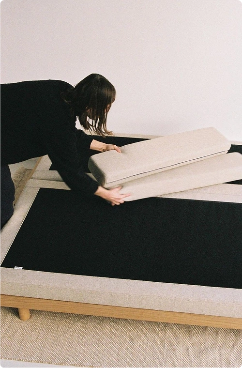 A girl is making a bed