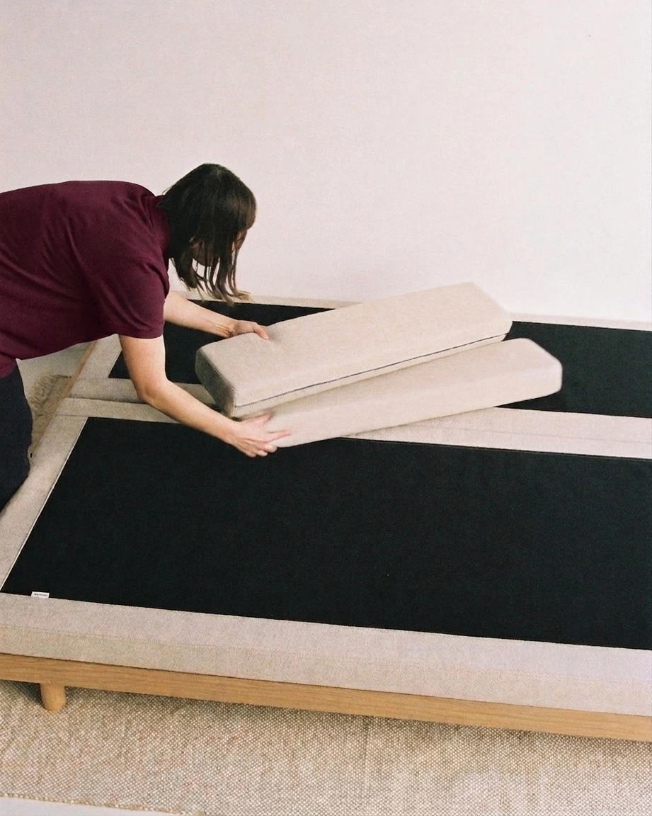 Yugo crew member completing furniture placement in a bedroom