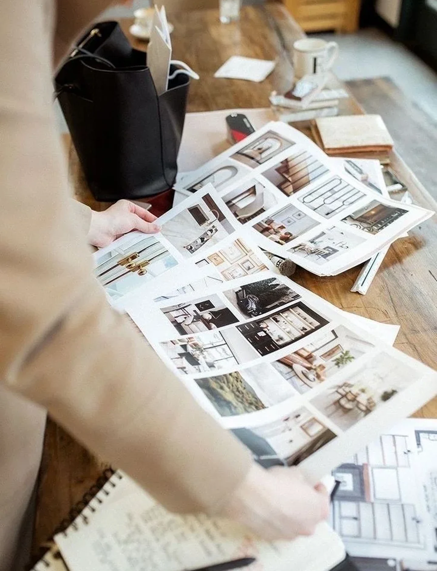 An interior designer arranging photographs and samples on a mood board