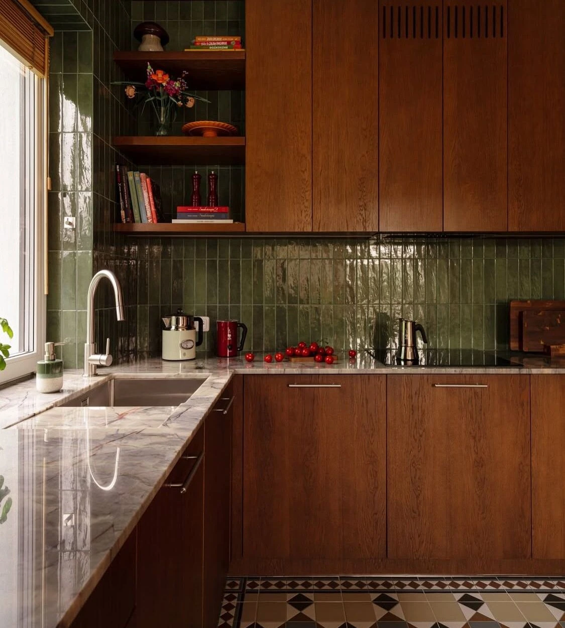 A walnut kitchen with custom millwork, a marble counter and green tile backsplash
