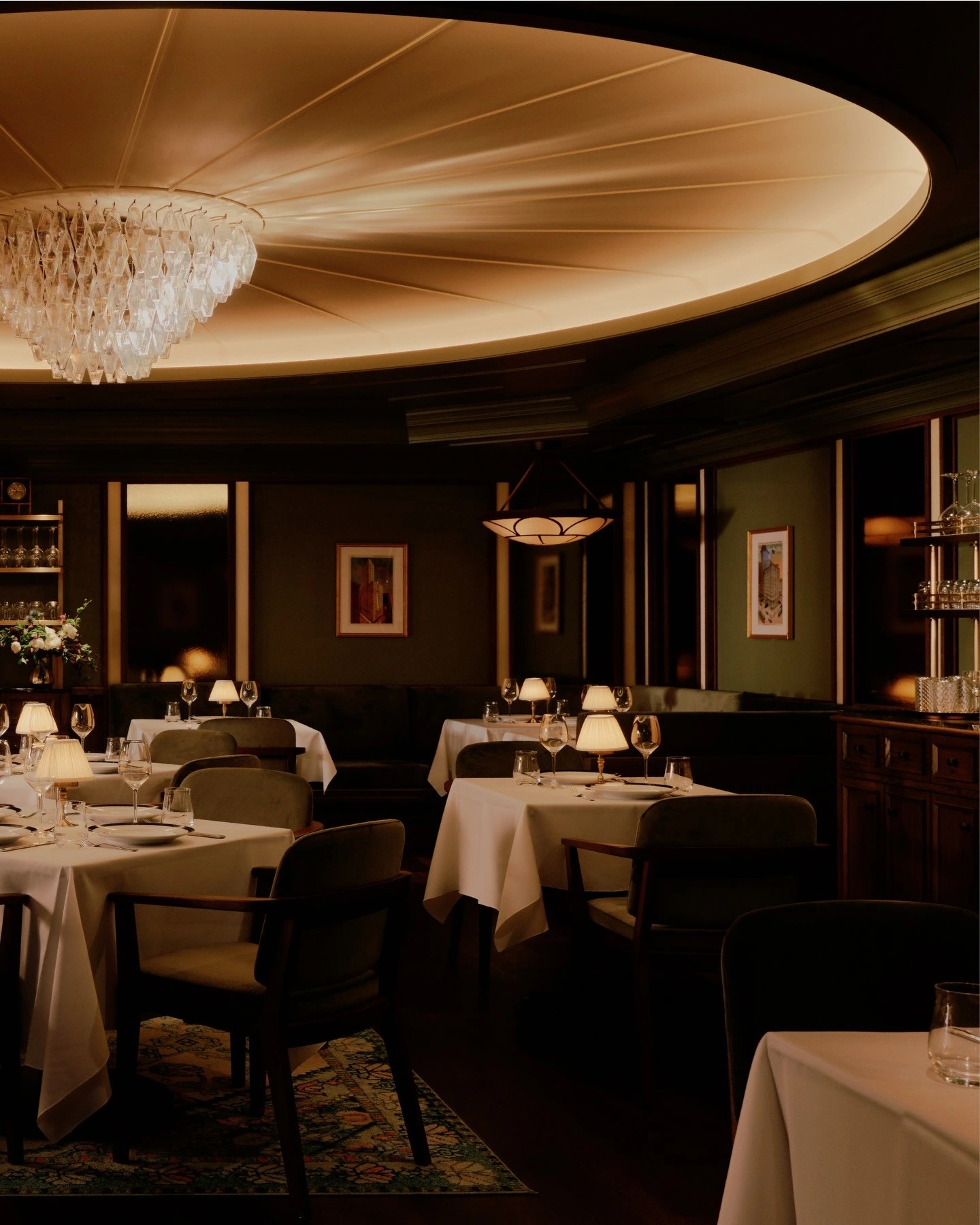 A restaurant dining room under a domed ceiling with white tablecloths