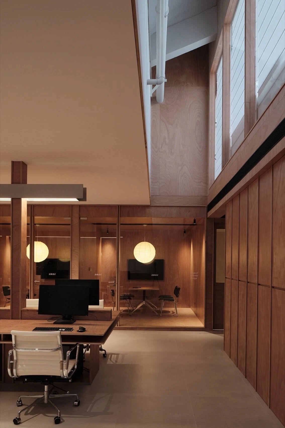 A wood-panelled professional office reception with warm lighting