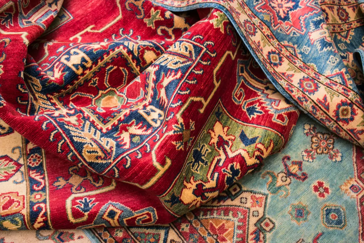 Folded Persian rugs in deep red and blue