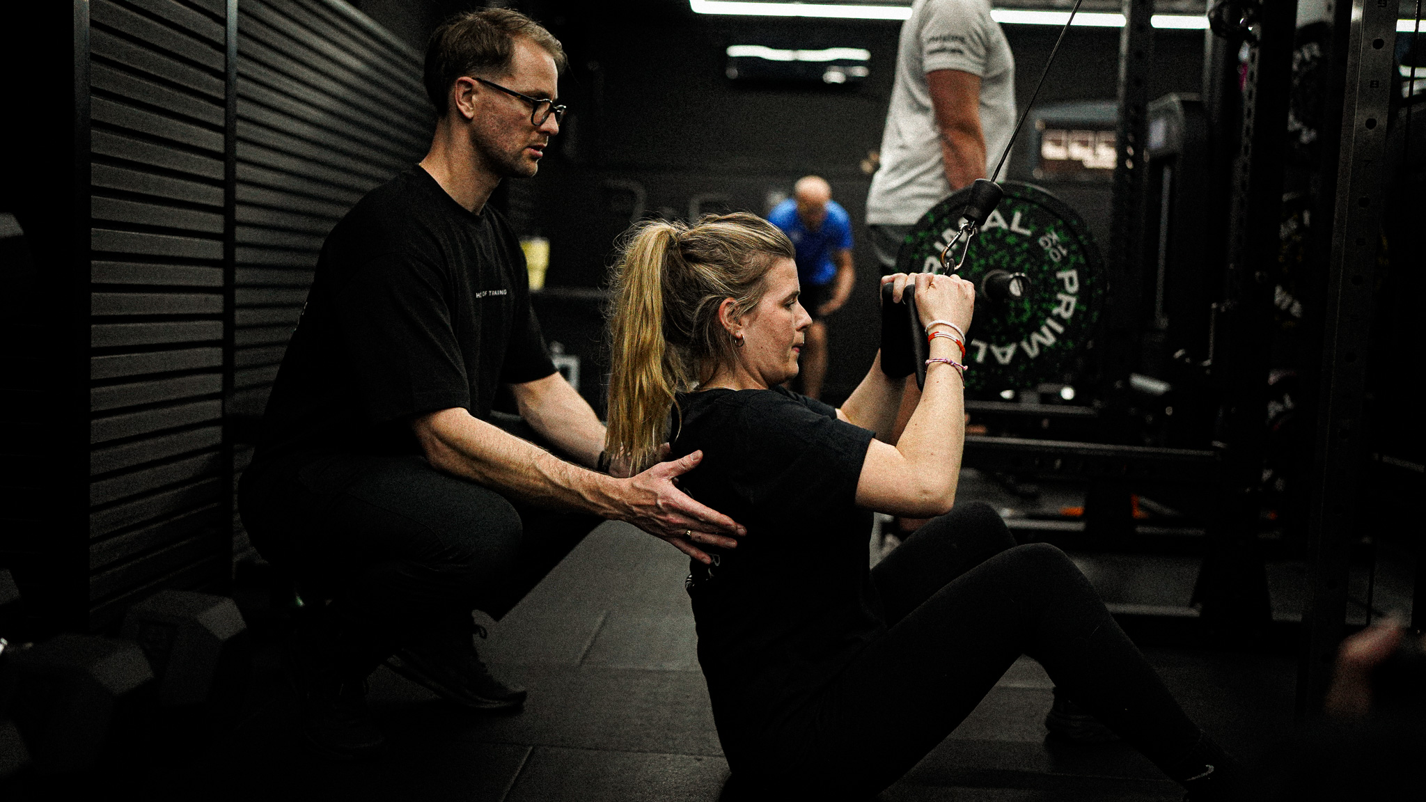 House of Training Personal trainer assisting client