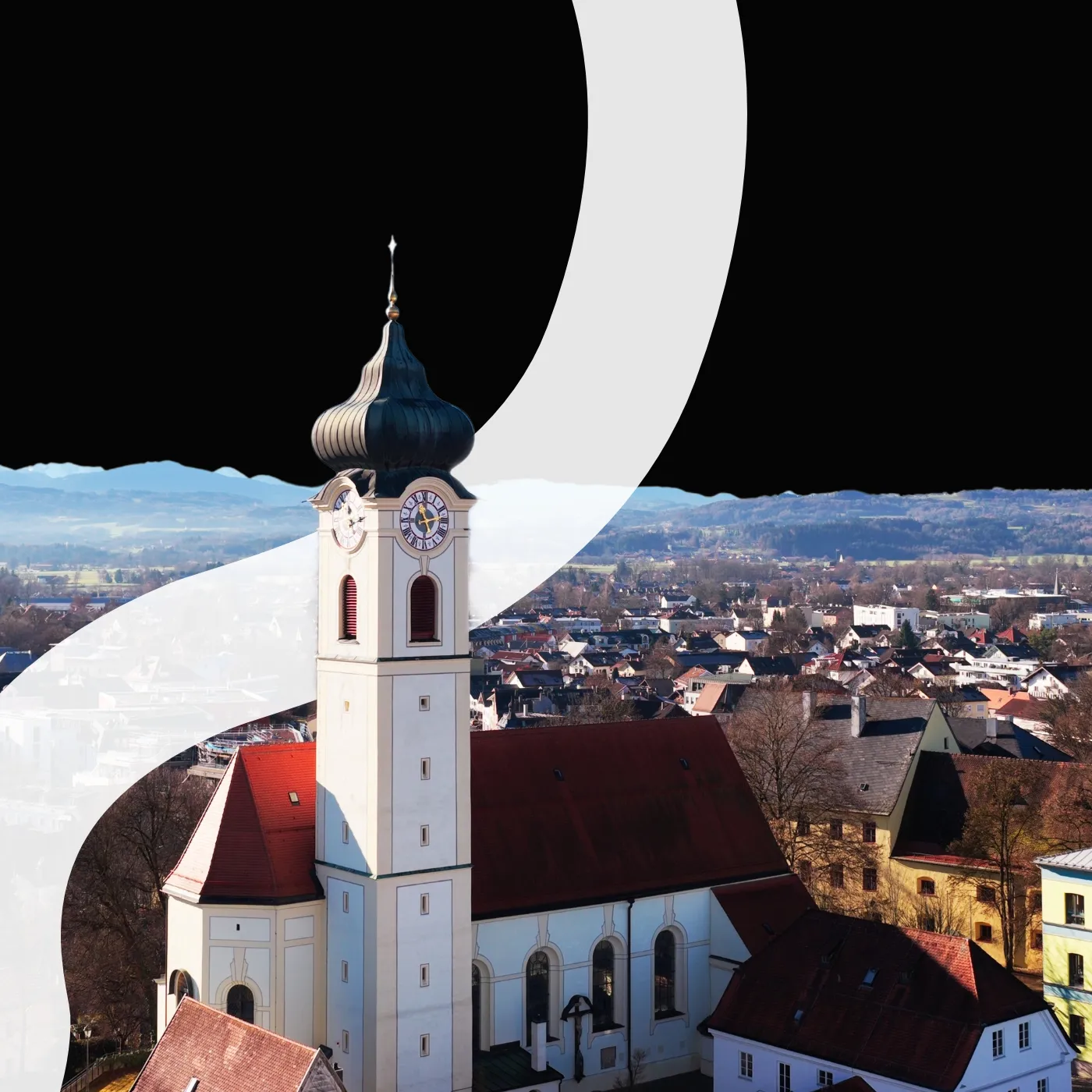 Blick über Bad Aibling mit Kirchturm und Alpenpanorama