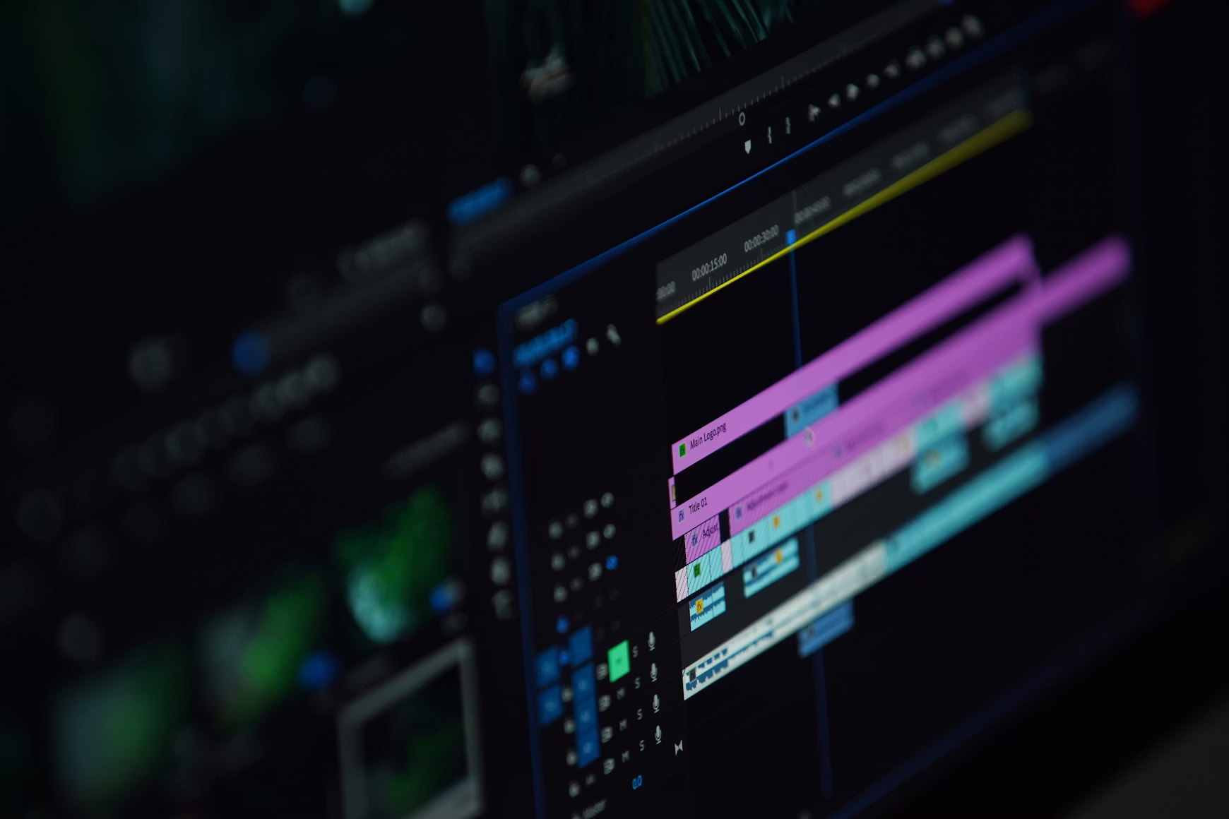 Close-up of a video editing software timeline with colorful tracks and controls on a dark screen.