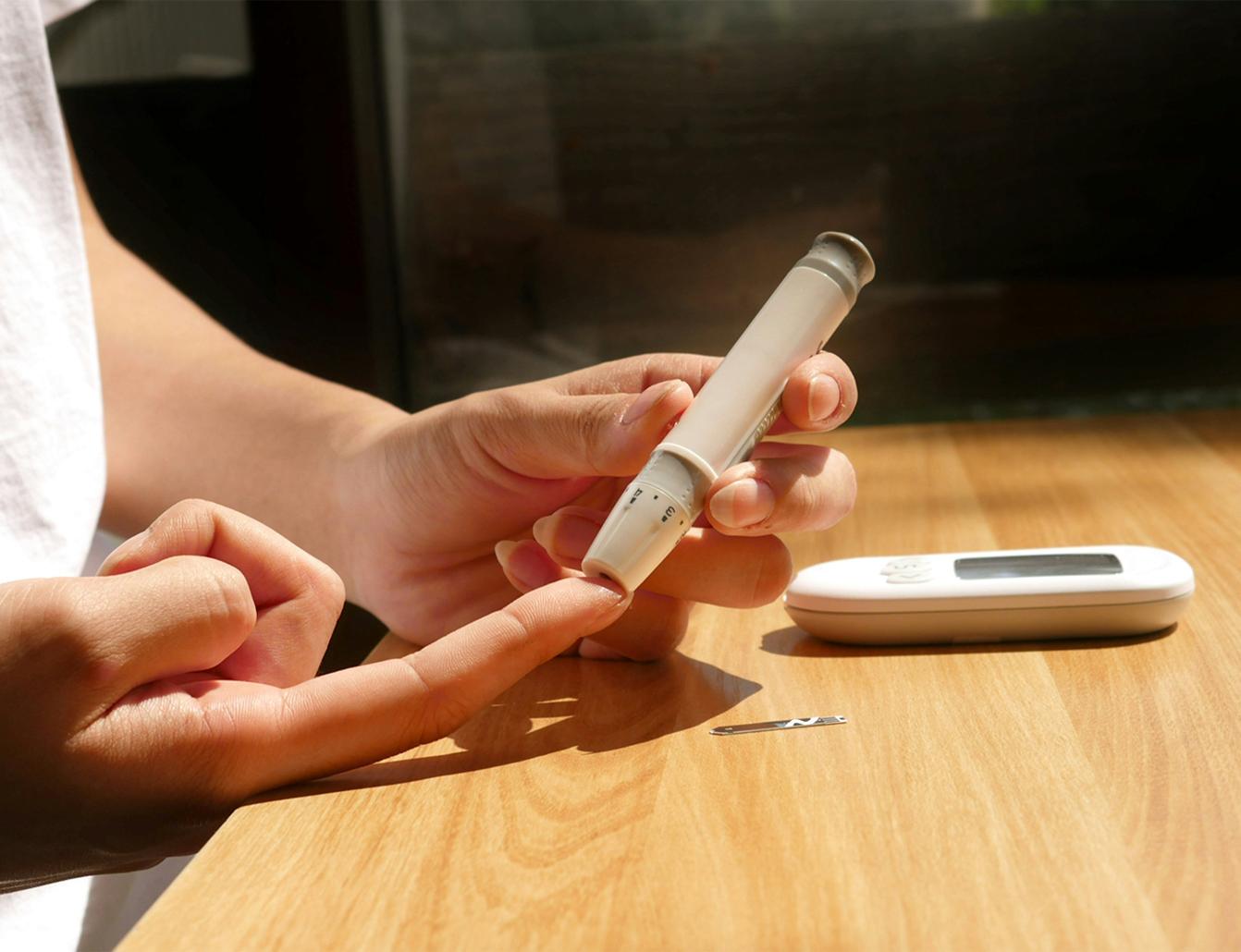 Blood glucose meter and test strip on a table