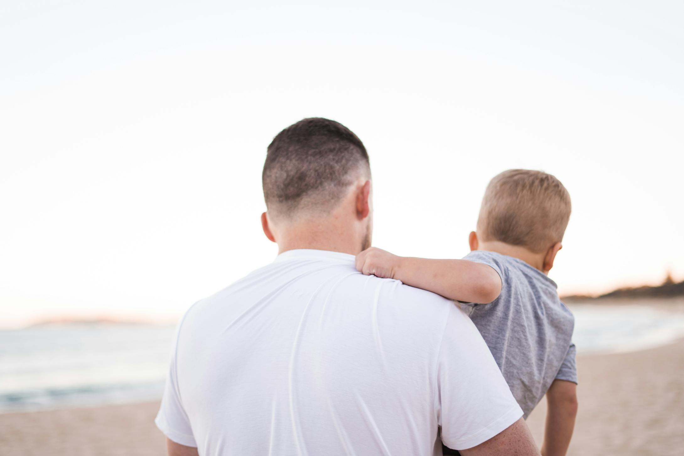 Three generations of men standing together