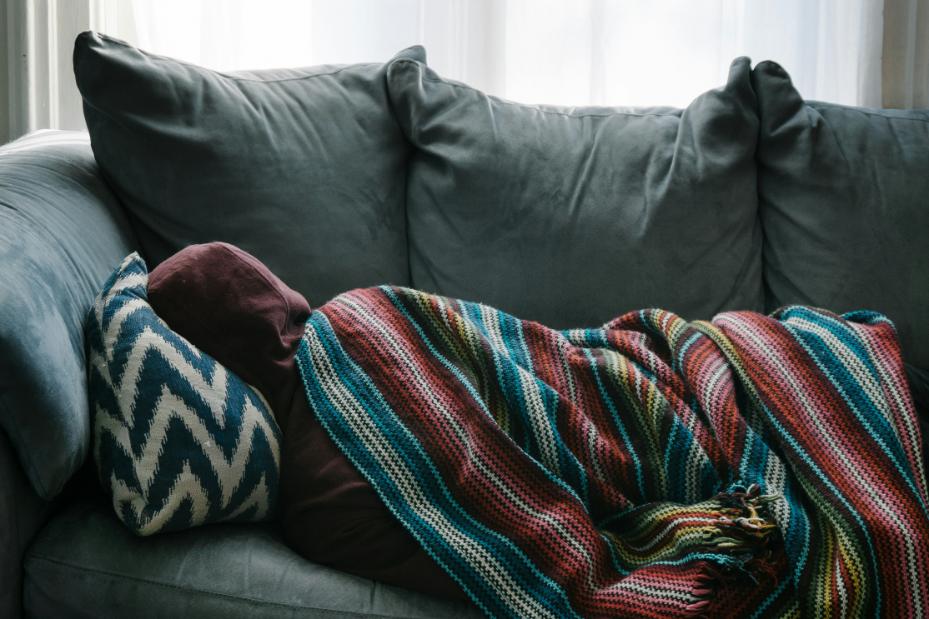Man unwell in bed with a cold