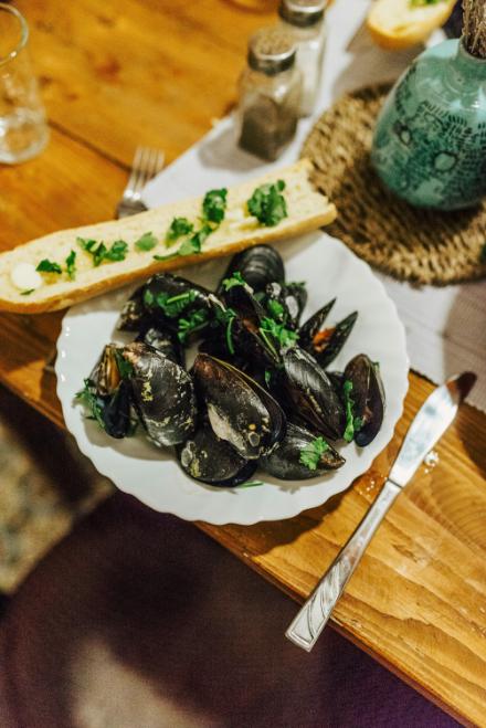 Open mussels in a red tomato broth with sourdough