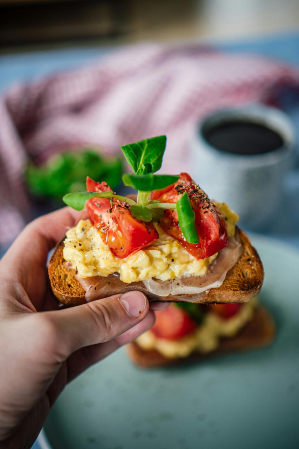 Yellow turmeric tofu scramble with spinach and tomatoes in a pan
