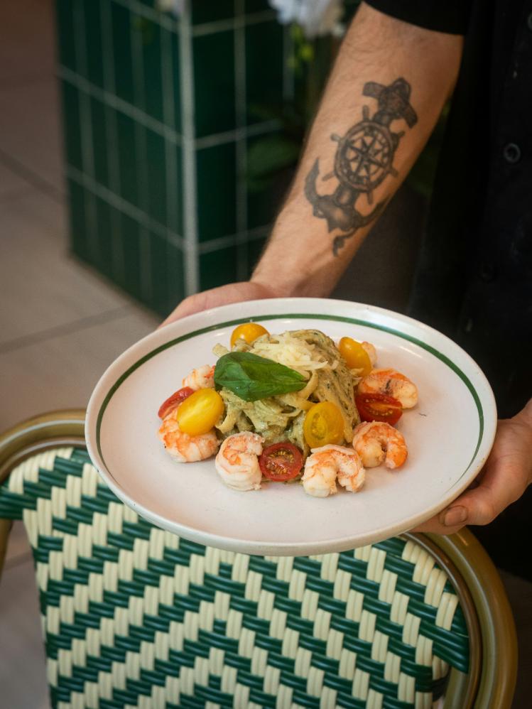 Thai green prawn curry with broccoli and red pepper in a bowl, with brown rice and lime