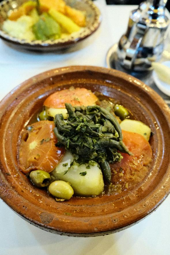 Moroccan chickpea and red lentil stew with spinach and carrots in a bowl, topped with coriander and lemon