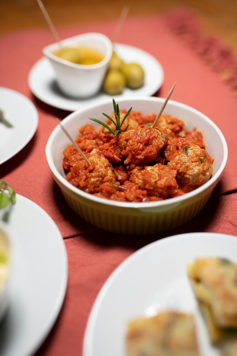Turkey meatballs in tomato sauce on a bed of courgette noodles, topped with basil and grated Parmesan