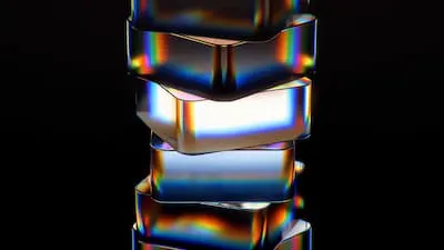 Stack of iridescent glass blocks on a black background