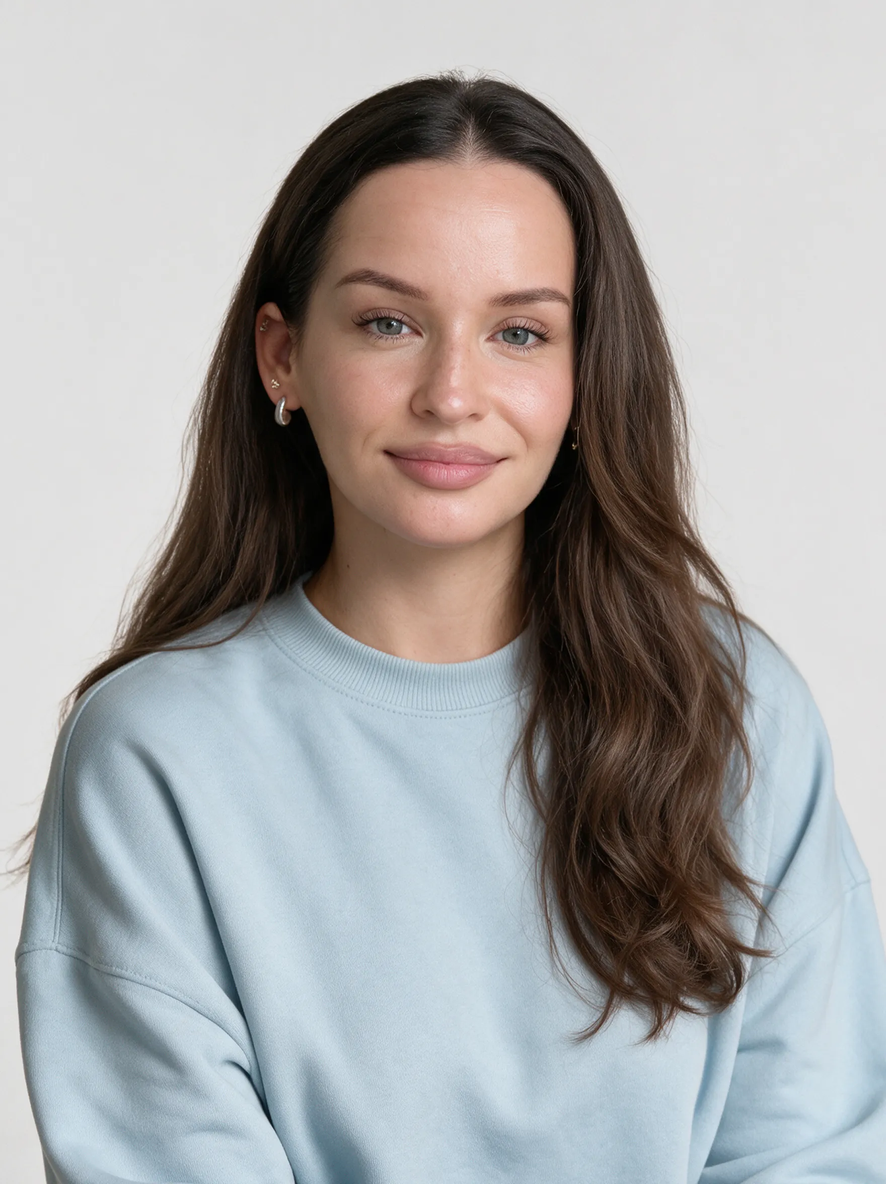 Portrait of a woman in a light blue sweatshirt